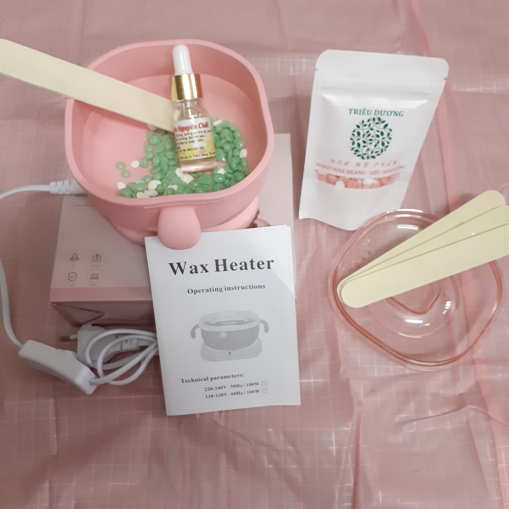 1 nồi nấu sáp wax lông silicon bỏ túi + sáp 50g màu Triêu Dương + Mỡ trăn 10ml. Tặng que wax