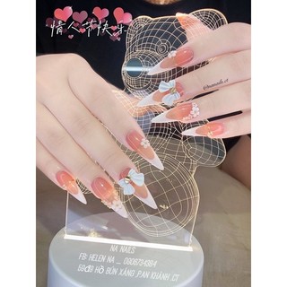 Móng úp NailBox thiết kế màu hồng thạch kẻ đầu móng trắng dáng dài nhọn đính nơ xinh