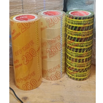 1 lốc băng keo 200 yard  + 1 đồ cắt băng keo SẮT/ Nhựa