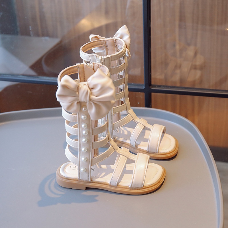 Xăng đan Chiến Binh La Mã Cổ Cao Đính Nơ Và Ngọc Trai Thời Trang Mùa Hè 2023 Cho Bé Gái