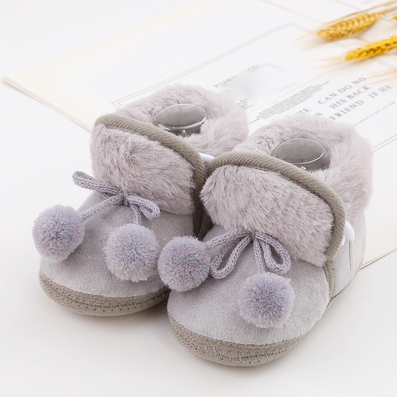 Baby cute boots sơ sinh nơ buộc tóc bóng trang trí giày bông trẻ mới biết đi dễ thương đáy mềm giày đi bộ giày đi tuyết