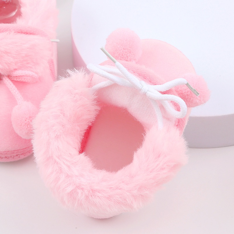 Baby cute boots sơ sinh nơ buộc tóc bóng trang trí giày bông trẻ mới biết đi dễ thương đáy mềm giày đi bộ giày đi tuyết