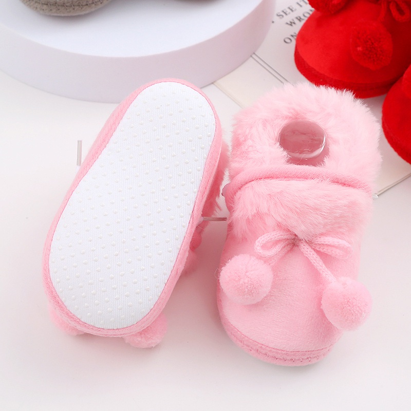 Baby cute boots sơ sinh nơ buộc tóc bóng trang trí giày bông trẻ mới biết đi dễ thương đáy mềm giày đi bộ giày đi tuyết