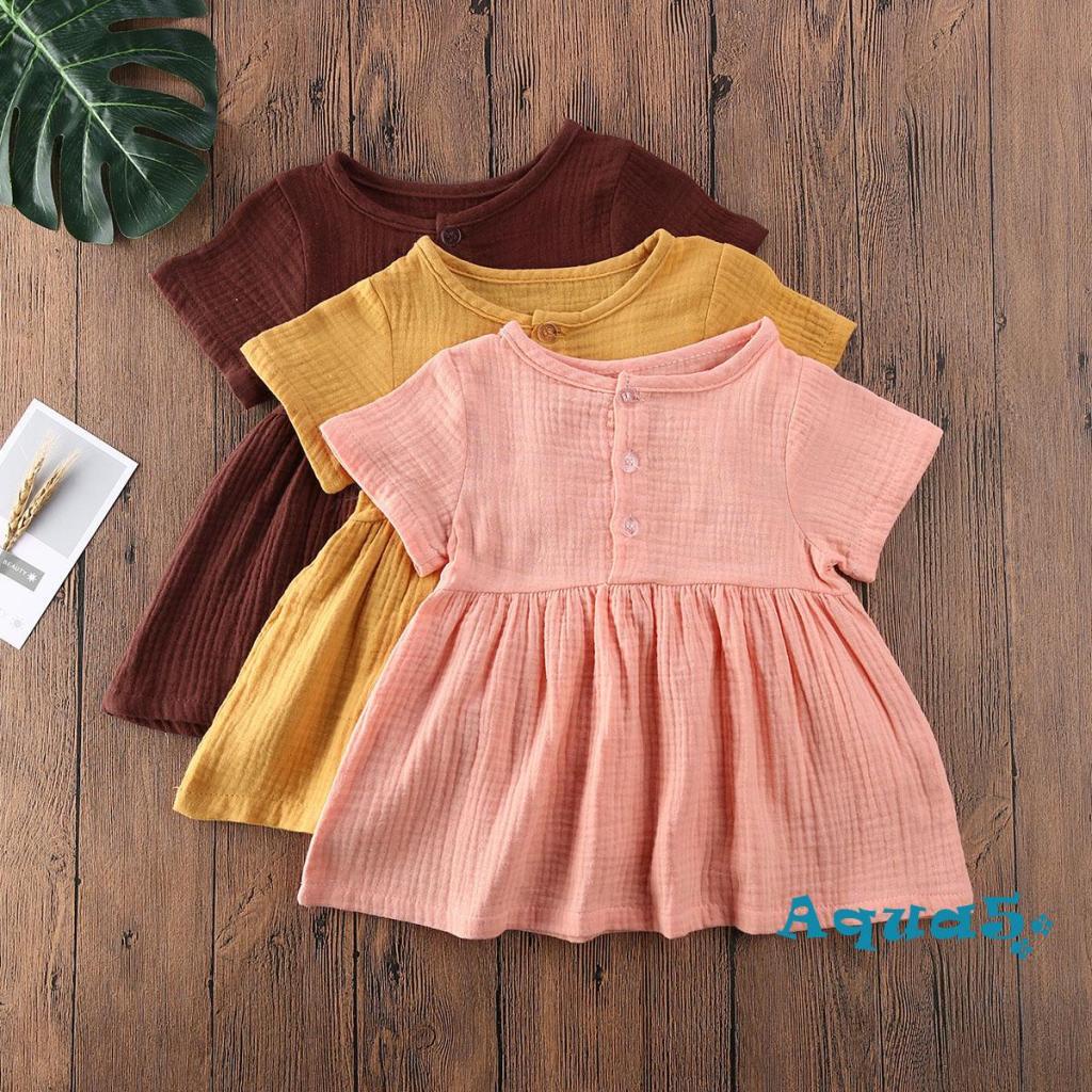 Đầm Mini Chữ A Tay Ngắn Màu Trơn Cài Nút Chất Liệu Cotton Lanh Thời Trang Mùa Hè Cho Bé Gái