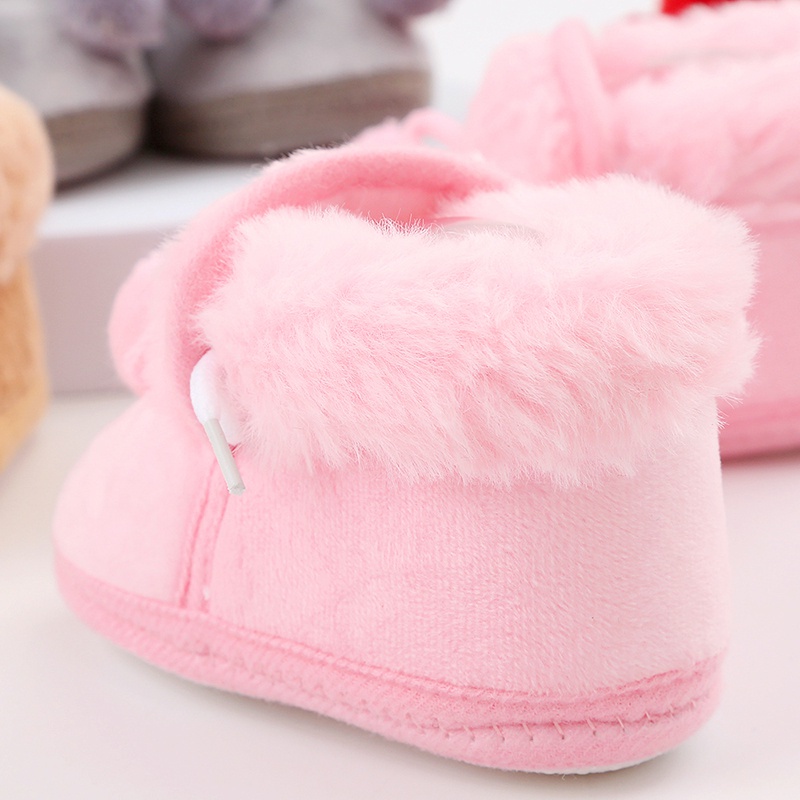 Baby cute boots sơ sinh nơ buộc tóc bóng trang trí giày bông trẻ mới biết đi dễ thương đáy mềm giày đi bộ giày đi tuyết
