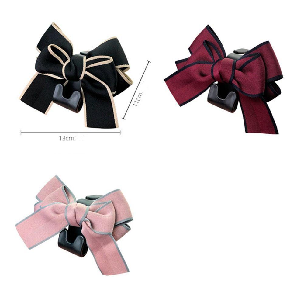 Móc Treo Đồ Gắn Lưng Ghế Xe Hơi Hình Nơ Bằng Nhựa Đa Năng Tiện Dụng