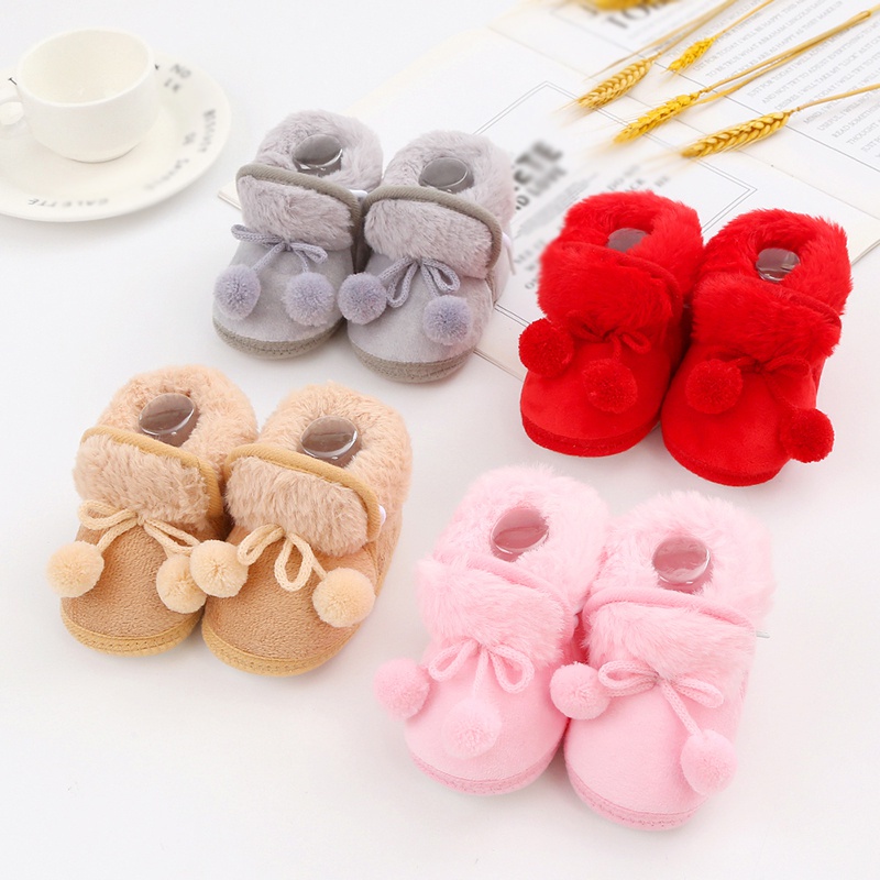 Baby cute boots sơ sinh nơ buộc tóc bóng trang trí giày bông trẻ mới biết đi dễ thương đáy mềm giày đi bộ giày đi tuyết