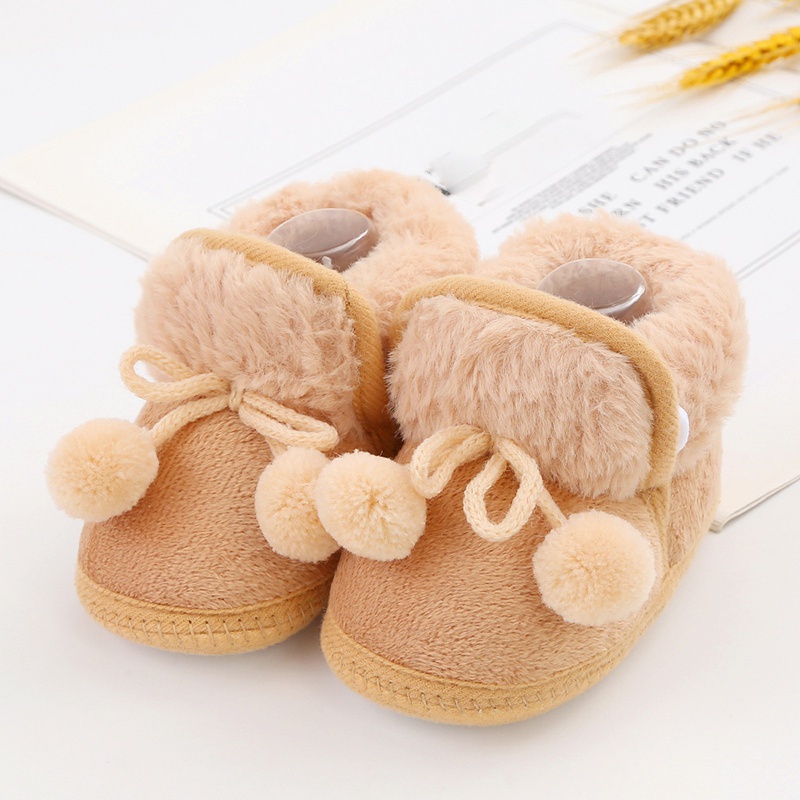 Baby cute boots sơ sinh nơ buộc tóc bóng trang trí giày bông trẻ mới biết đi dễ thương đáy mềm giày đi bộ giày đi tuyết