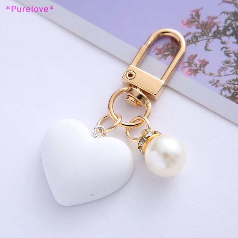 Purelove &gt; Móc Khóa Hình Trái Tim Mặt Nhám Màu Trắng Đen Đính Ngọc Trai Thời Thượng Kèm Túi Đựng Tai Nghe Cho Cặp Đôi /