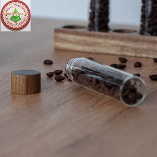 Ống thủy tinh đựng hạt cà phê kèm dụng cụ mở kín khí
