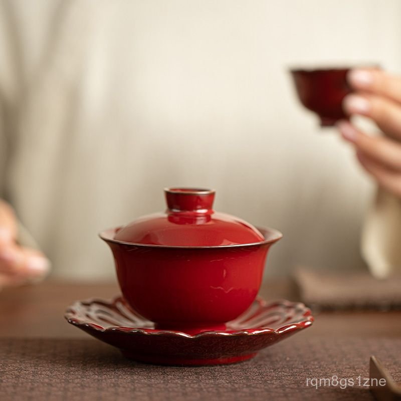 Red gaiwan ceramic tea set with lotus-shaped tea pot and tea bowl