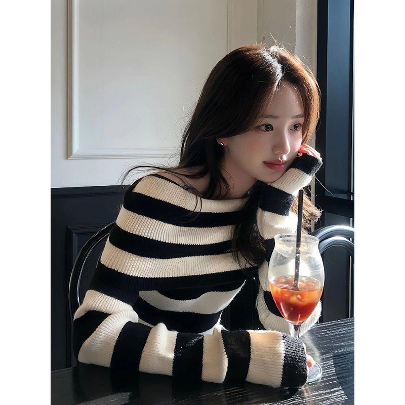 Early autumn outfit: off-shoulder knit sweater, black and white striped long-sleeve top, women's off