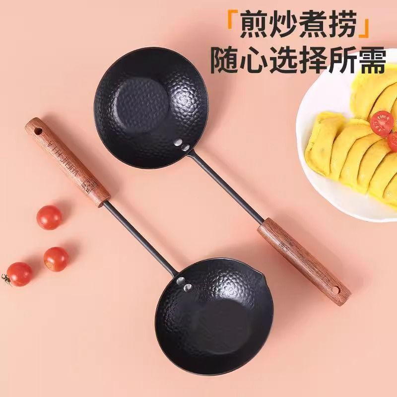 Frying eggs in a small pan with a handheld spatula12y New product small mini frying pan with long ha