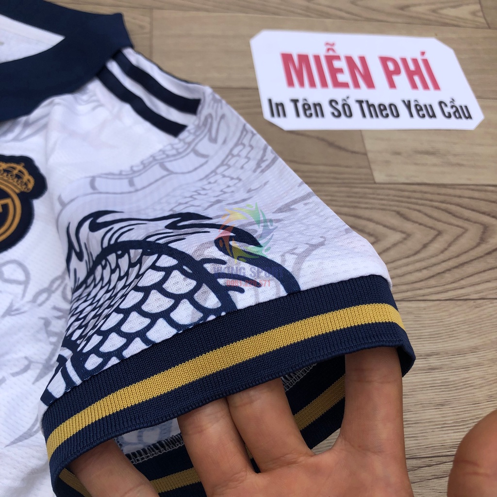 Bộ Quần Áo Bóng Đá Real Madrid Vân Rồng Vải Gai Thái Có In Tên Số Theo Yêu Cầu