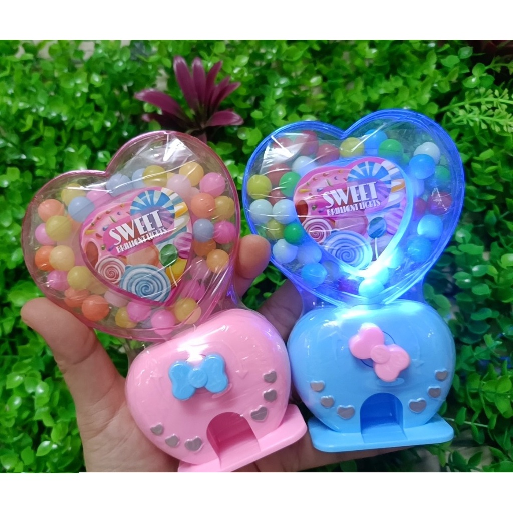 Kẹo đồ chơi máy bắn kẹo trái tim love phát sáng có đèn