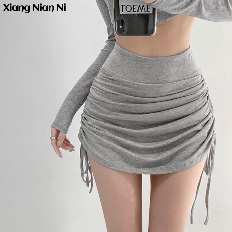 Chân váy Xiang Nian Ni ngắn dáng chữ A mỏng lưng cao xếp ly dây rút bên hông màu trơn phong cách quyến rũ 2023 cho nữ