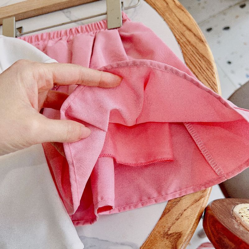 Set áo polo kèm chân váy thô bé gái