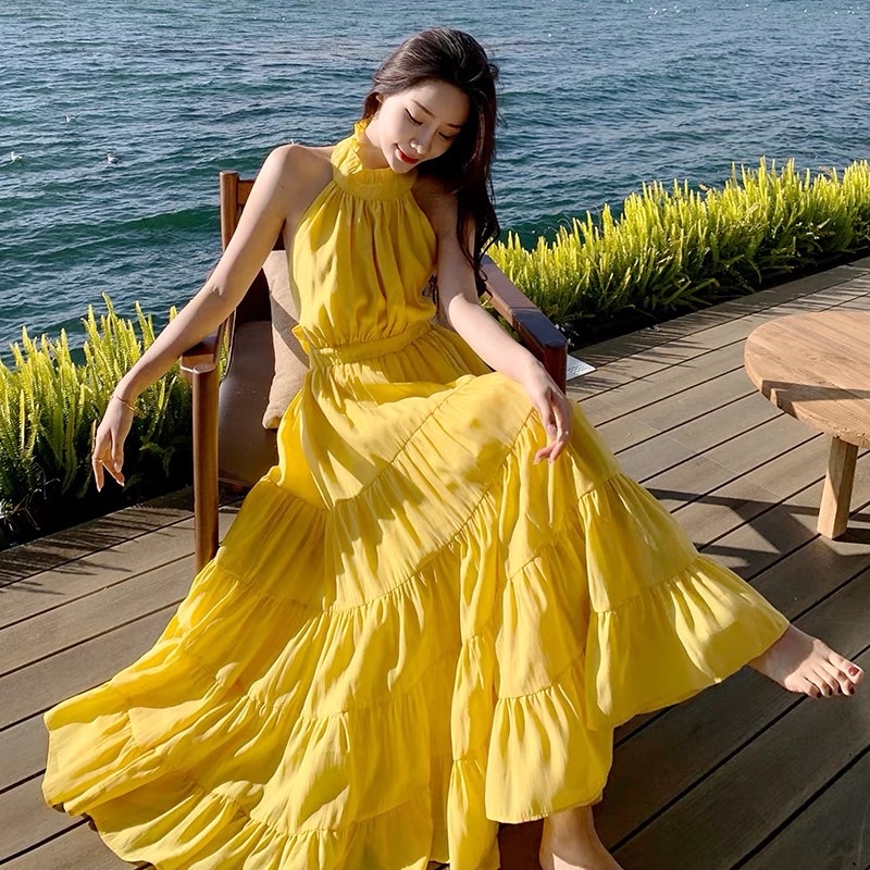 Đầm maxi đầm maxi đi biển màu vàng thắt nơ đầm hở lưng ,váy nhiều tầng ,váy đi biển