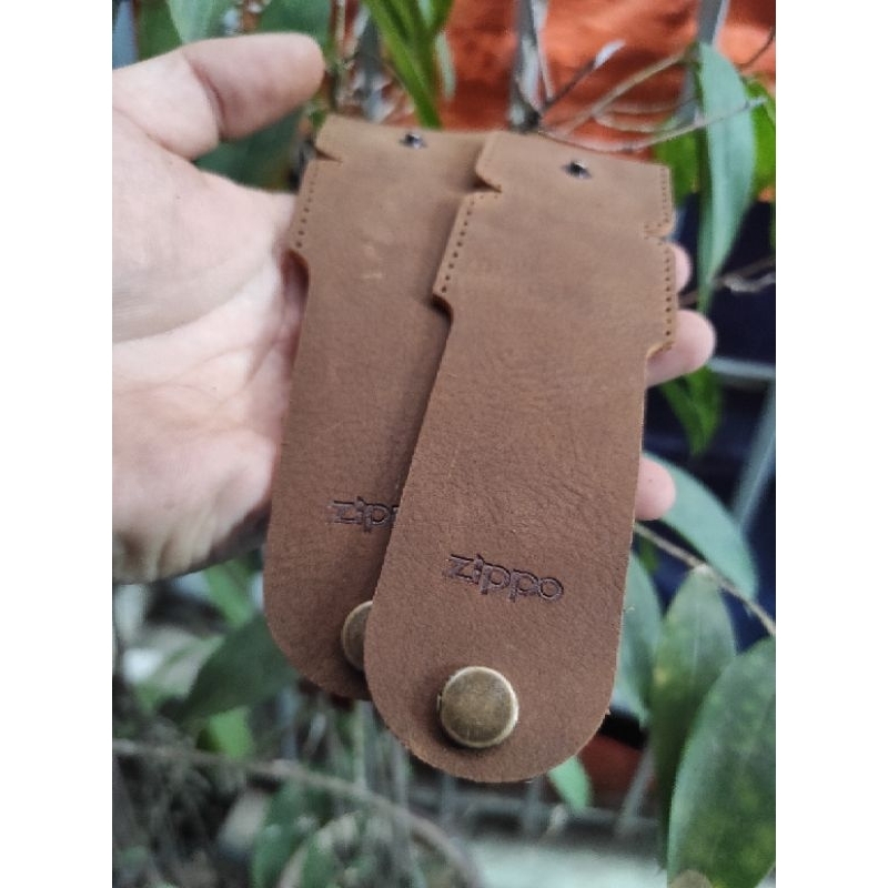 Bao da cầm tay zippo