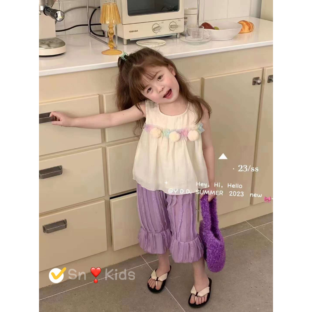 Set áo kem gắn cục bông quần sóng tím bé gái