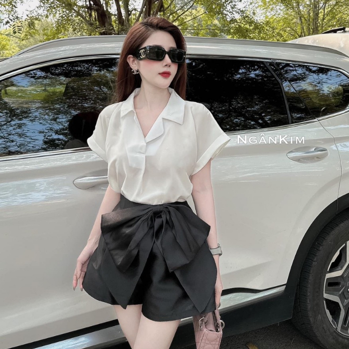 Set áo sơ mi trắng thiết kế chất lụa ngọc trai tay hến cổ vesy cách điệu kèm quần váy tacta đen đính nơ to sang chảnh
