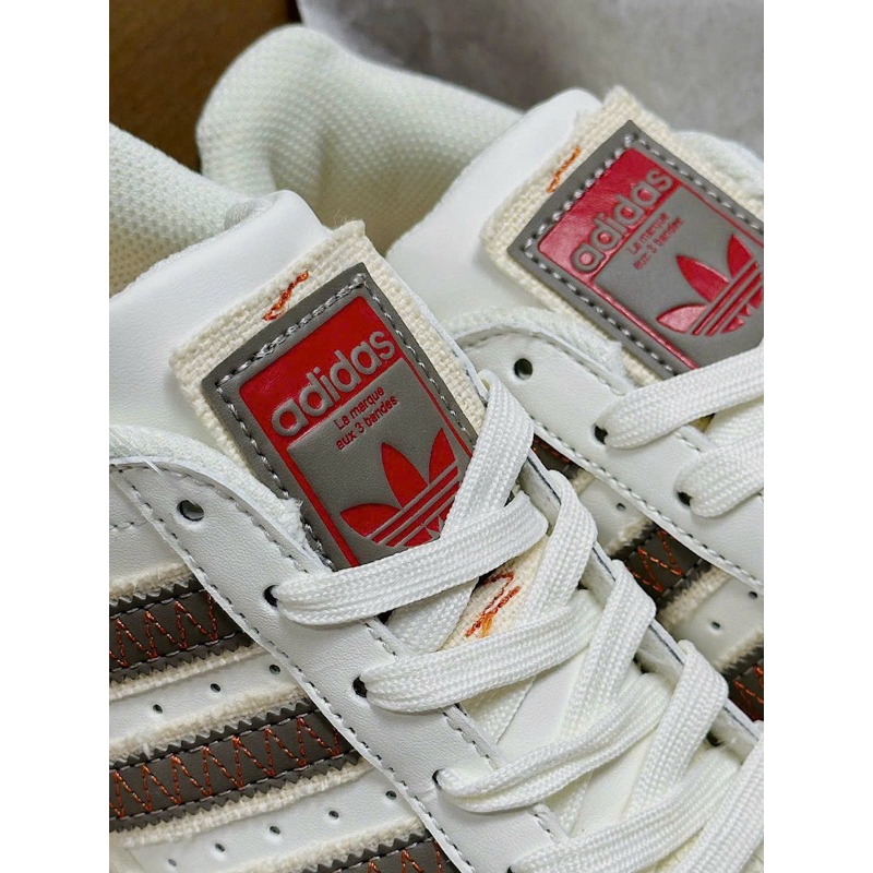 Giày sneaker superstar kem nâu viền đỏ