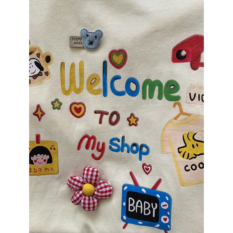 Áo Phông Chibi Baby Welcome To My Shop Dễ Thương Màu Be Vàng