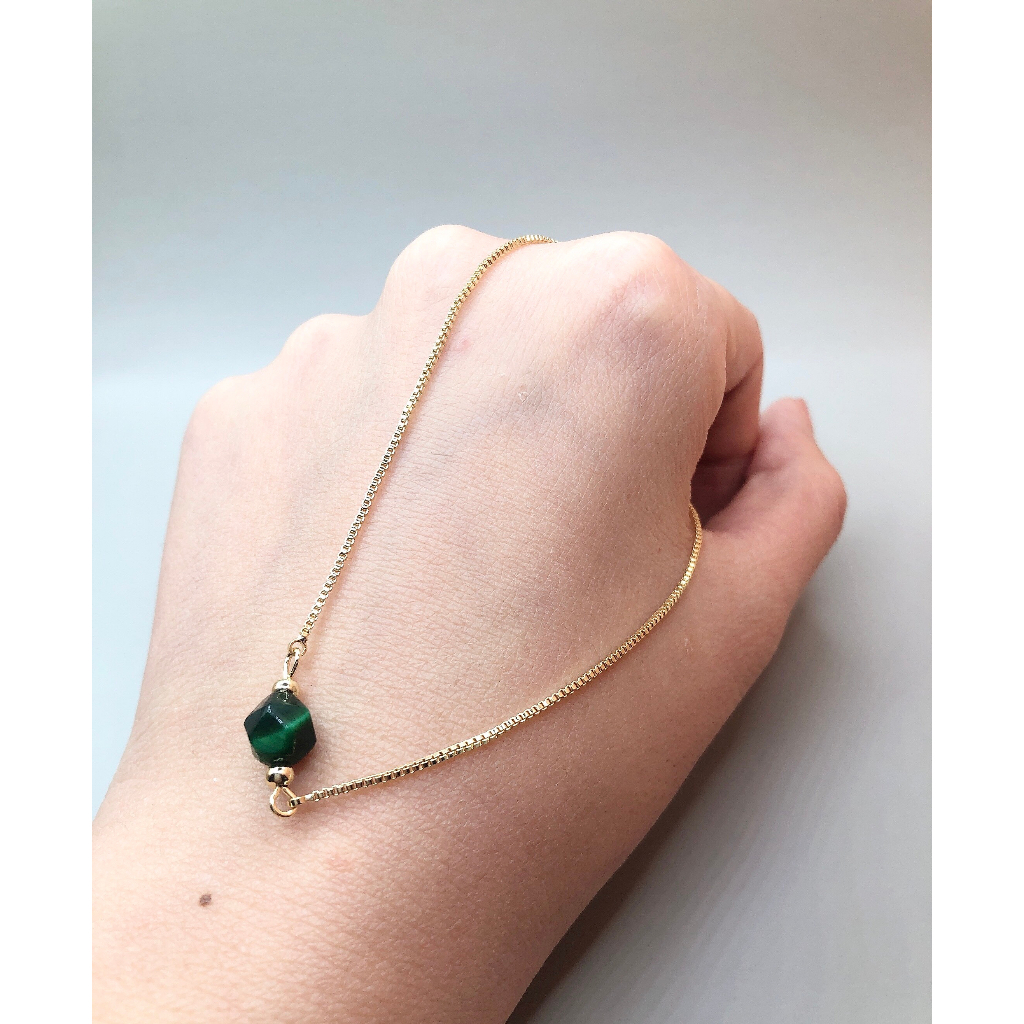 Vòng dây lụa rút đá mắt hổ xanh cắt giác 7mm si tuyển Nhật