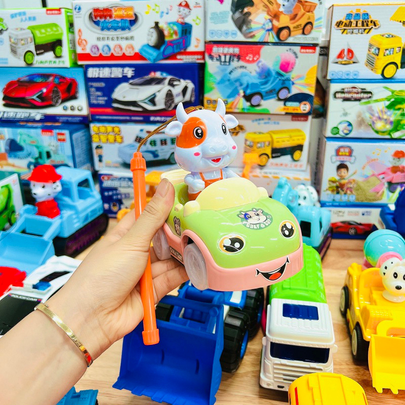 Đồ chơi bò sữa lái xe hoạt hình dễ thương,phát đèn và nhạc vui nhộn