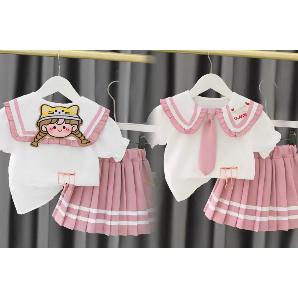 Set học sinh thêu cô gái sau lưng bé gái