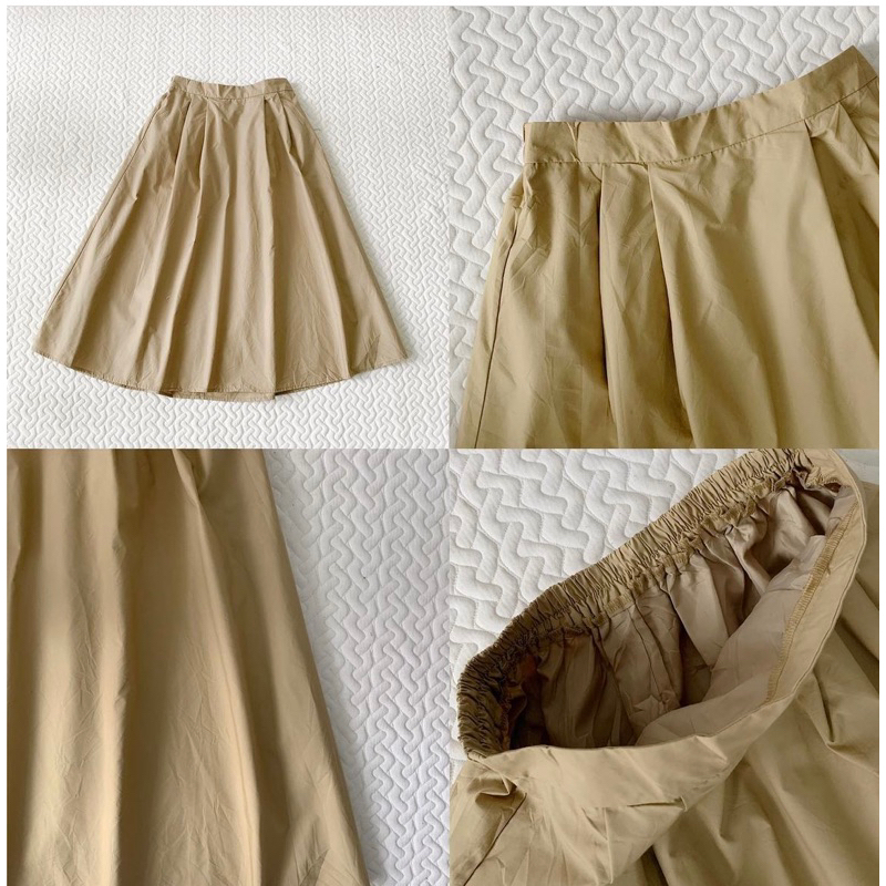 Chân váy GU xoè màu be size M 99%