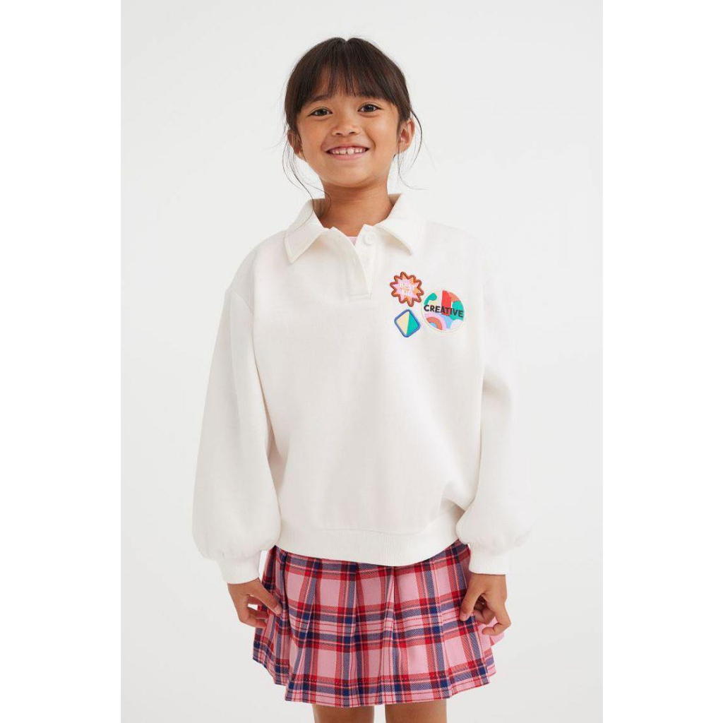 Áo nỉ polo trắng gắn stick bé gái