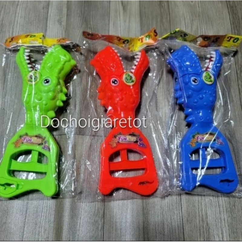 ) Đồ chơi khủng long cạp tay