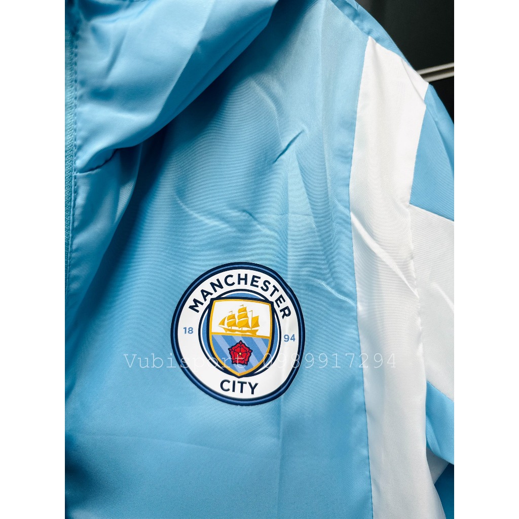 Áo gió thể thao các clb Manchester city màu xanh thể thao 2 lớp có túi mũ liền chống nước