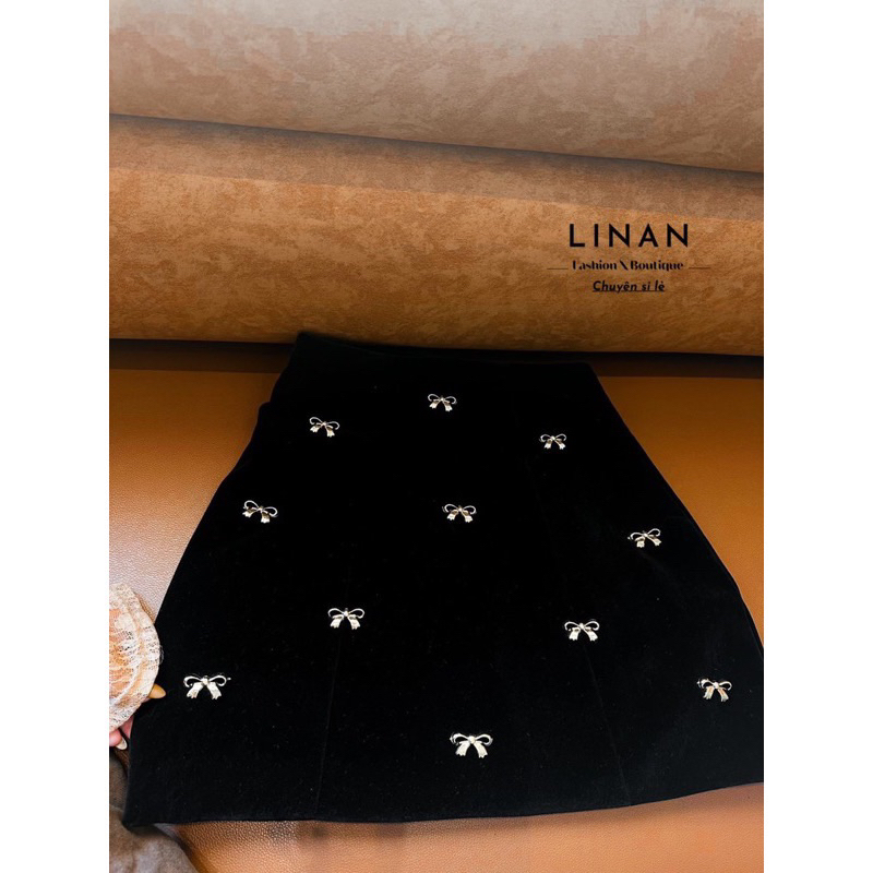 Chân váy nhung chữ A đính nơ