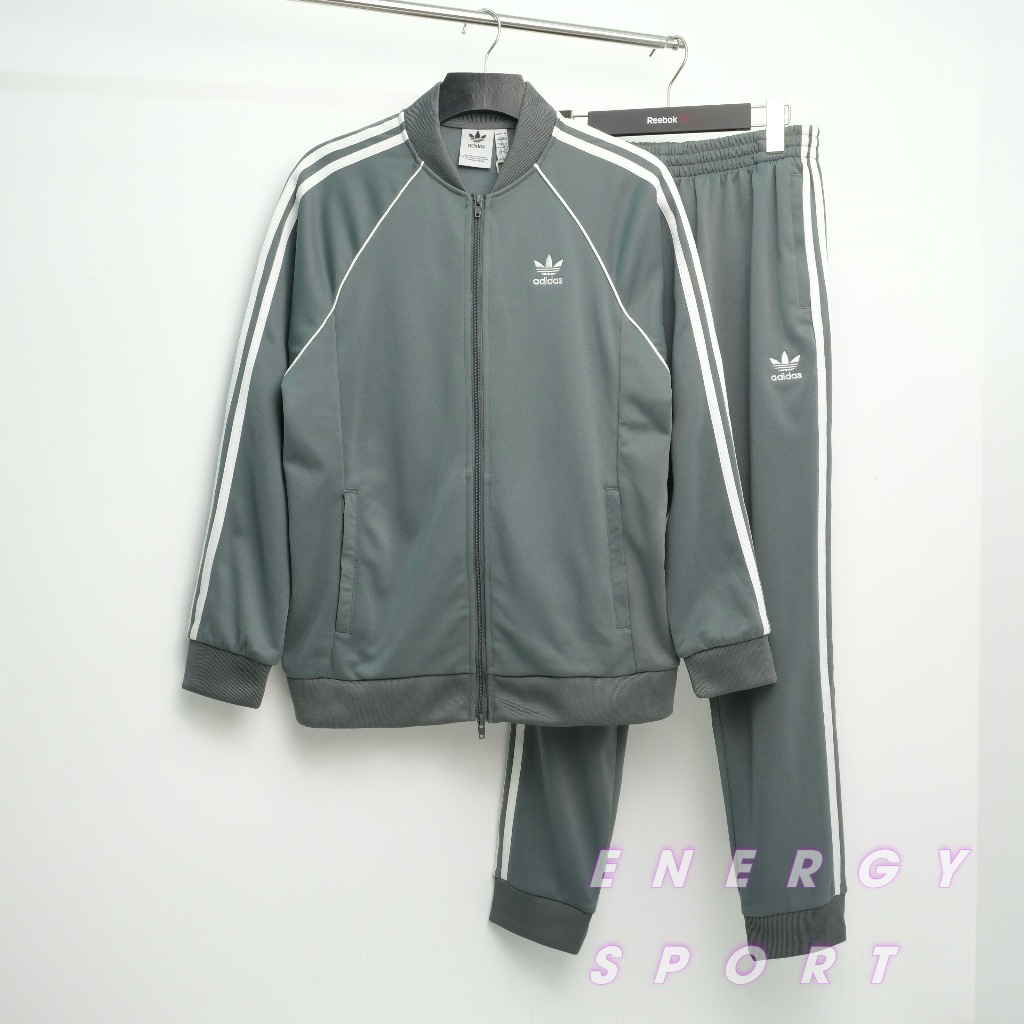 Bộ Quần Áo Thể Thao Unisex Nam Nữ Adidas Adicolor Classic Primeblue SST Track - Màu Xi Măng