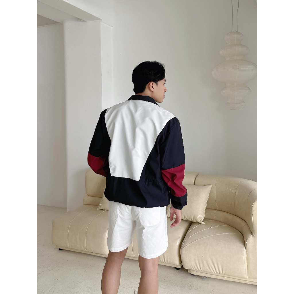 Áo khoác dù khóa zip lỡ phom unisex CAPMAN màu trắng phối đen đỏ