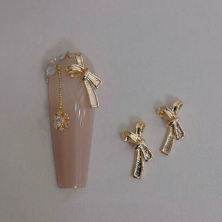 Charm nơ kim loại phủ sứ đính móng