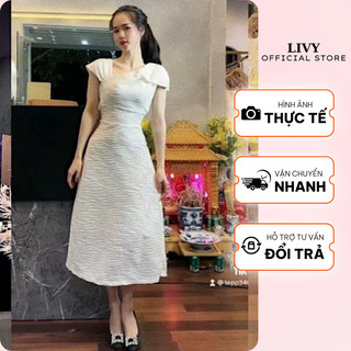 Váy Nữ Dài Vai Thắt Nơ Lệch Vải Xốp Vân Nổi Tôn Dáng Sang Chảnh Freesize