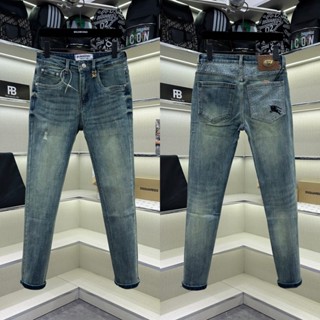 Quần jean bò nam PB slimfit xanh bụi trơn cào xước nhẹ tag logo eo phối dập vân monogram túi sau QJ569P