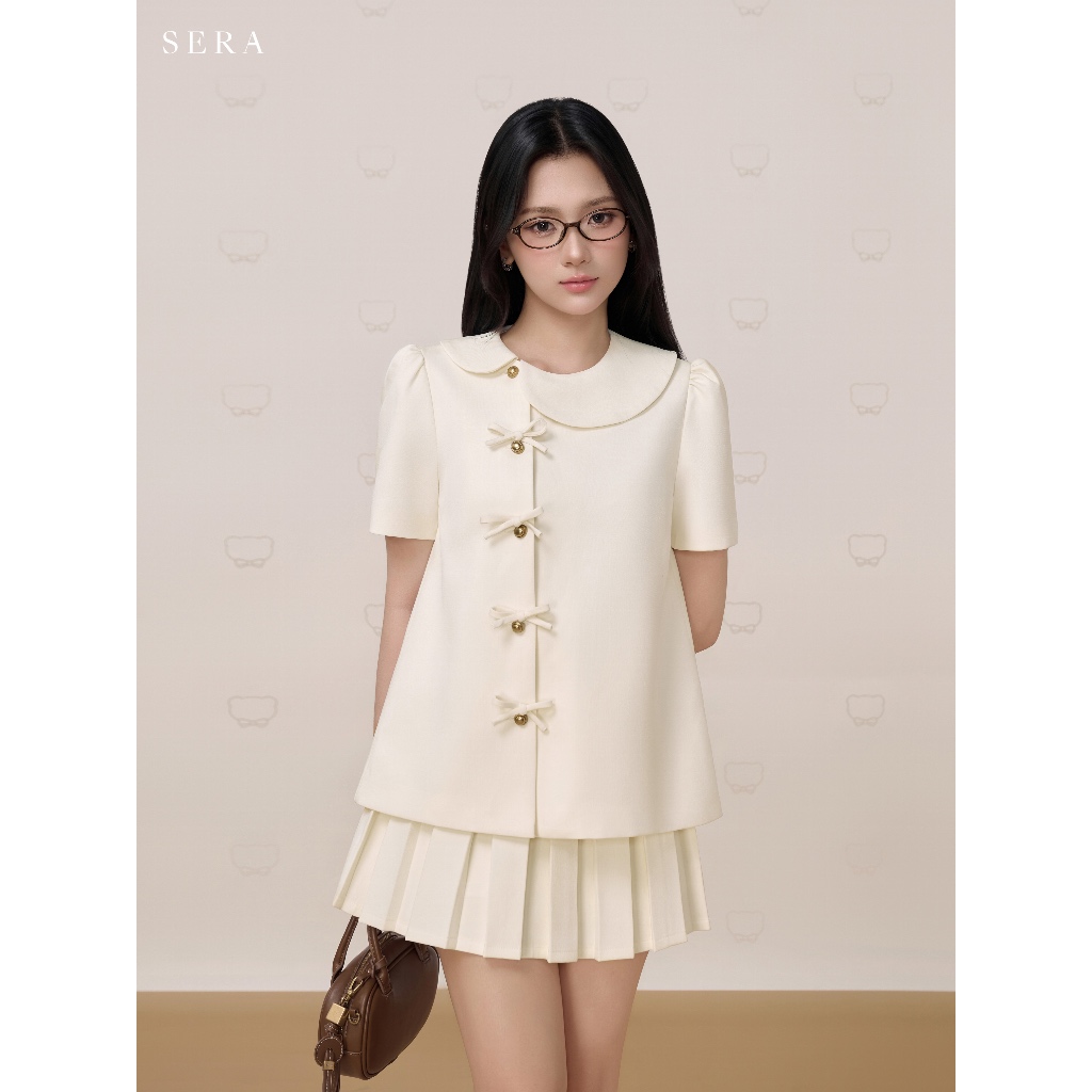 SERA - Set áo dáng A cổ lệch đính nơ và chân váy xếp ly hộp Sana (TÁCH SET) | BigBuy360 - bigbuy360.vn