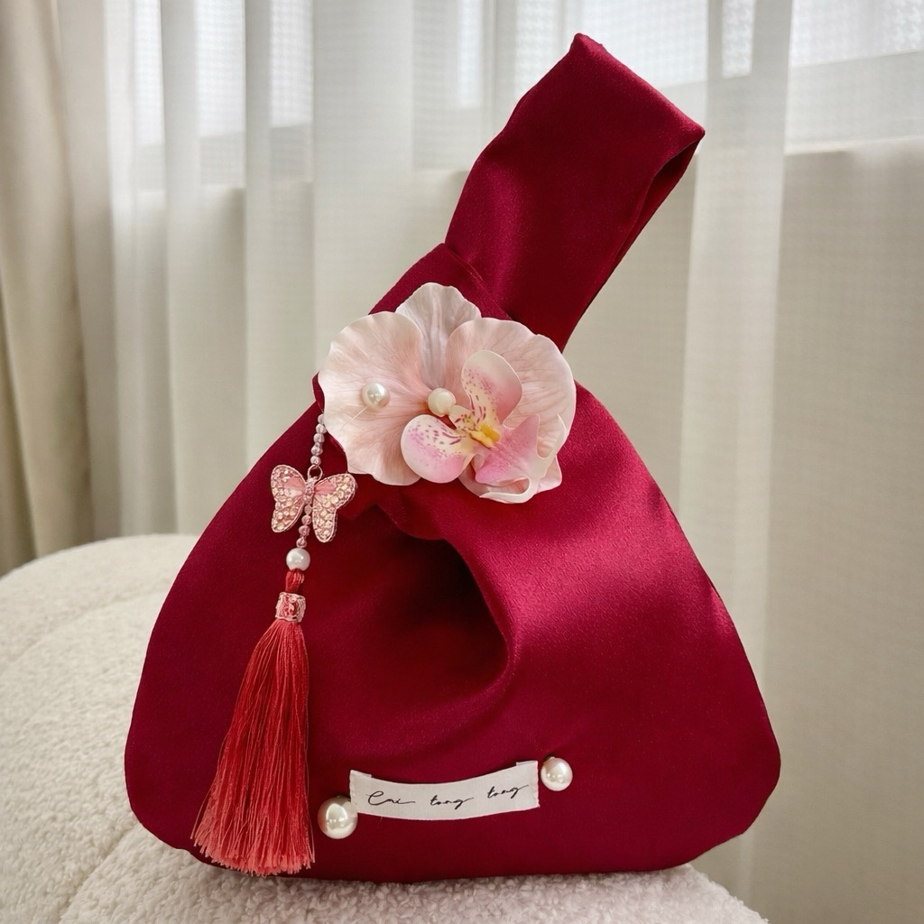 Túi lụa cầm tay có gắn hoa và tua rua trang trí dùng cùng áo dài loại cao cấp
